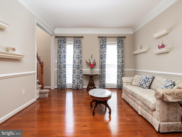 living room with baseboards, stairs, ornamental molding, and wood finished floors