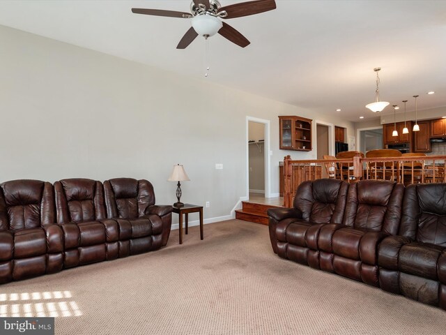 living area with light carpet, ceiling fan, baseboards, and recessed lighting