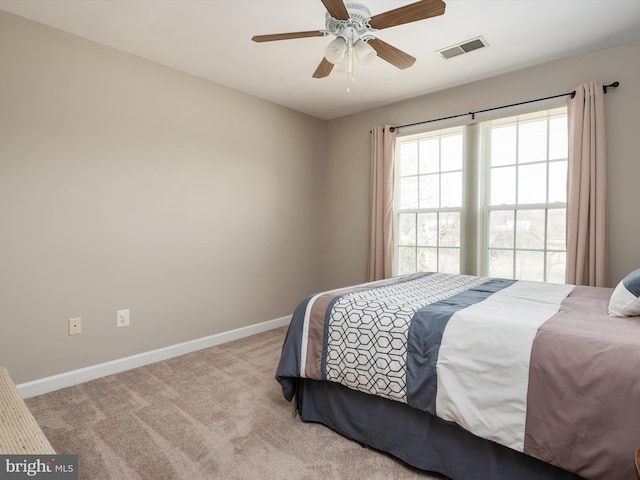 bedroom with carpet floors, visible vents, baseboards, and a ceiling fan