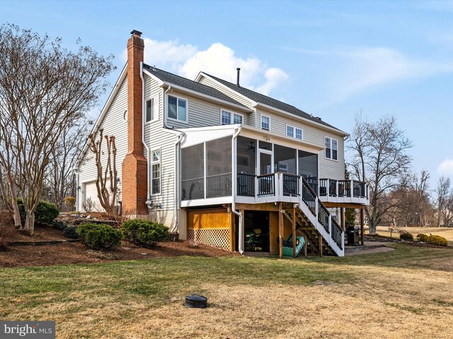 rear view of property with a garage, a lawn, a sunroom, a chimney, and stairway