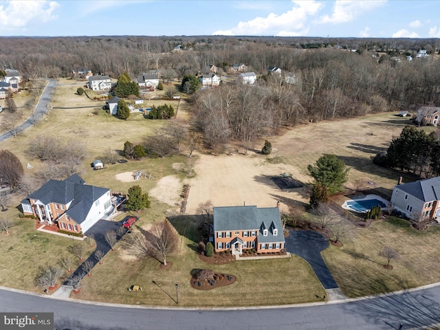 birds eye view of property featuring a wooded view