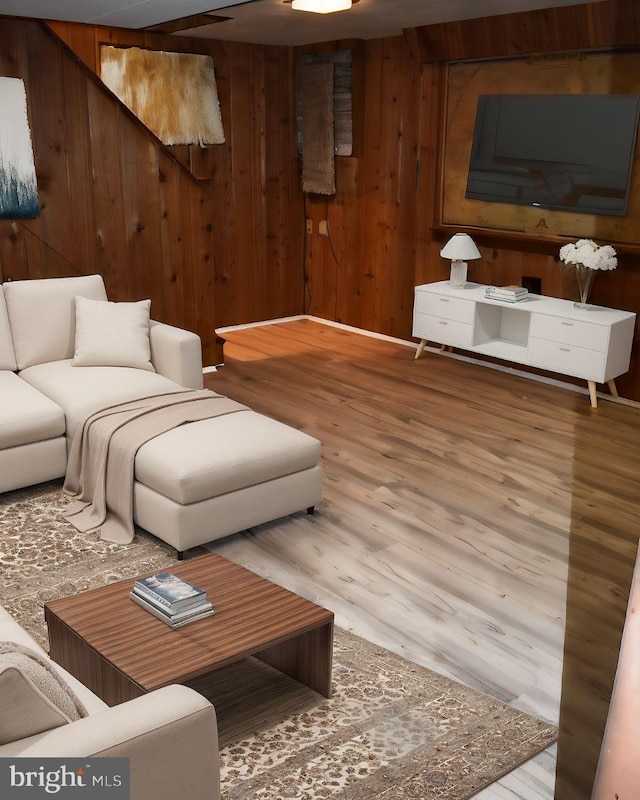 living room featuring wood walls and wood finished floors