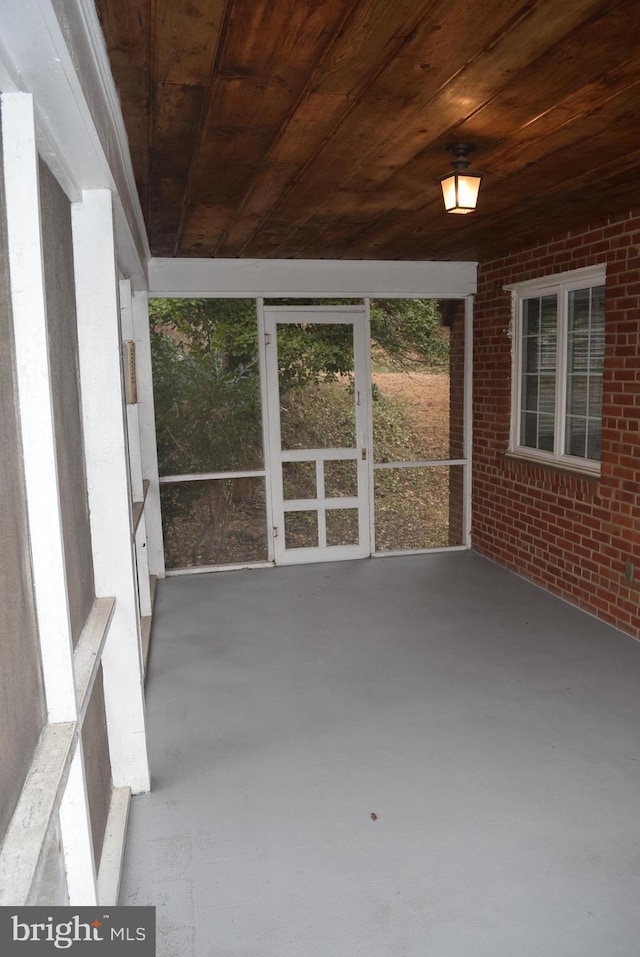 unfurnished sunroom featuring wood ceiling