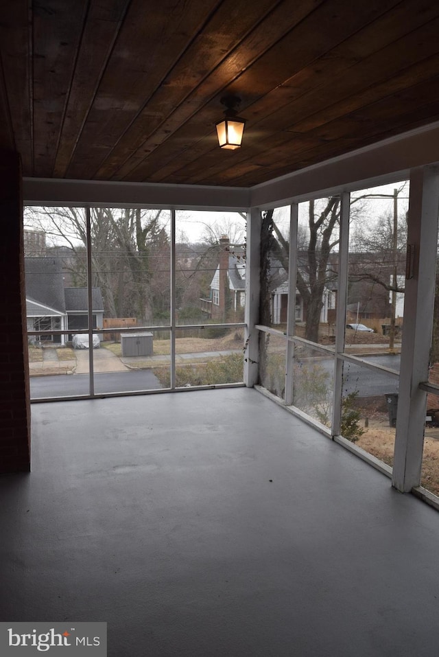 unfurnished sunroom featuring wooden ceiling