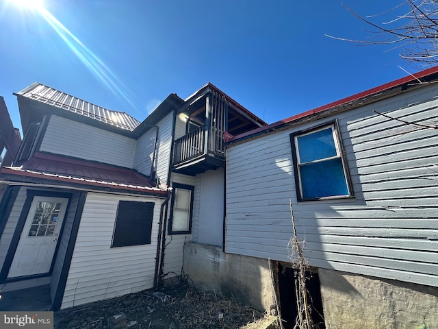 view of home's exterior with a balcony and metal roof