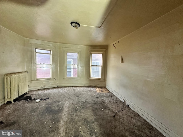 spare room featuring radiator heating unit