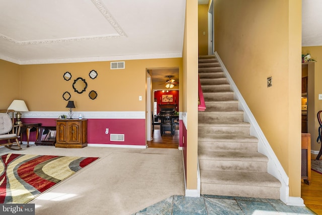 interior space featuring ceiling fan, visible vents, and baseboards