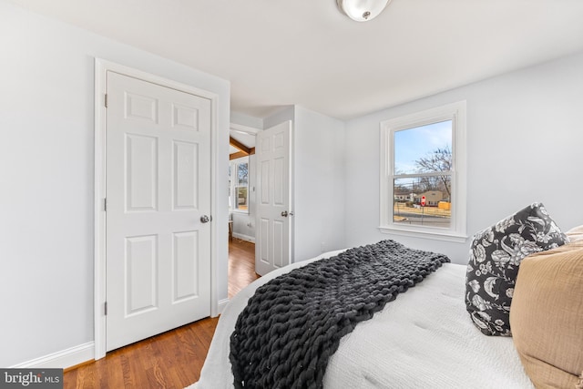 bedroom with wood finished floors and baseboards