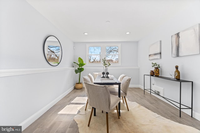 dining space with recessed lighting, baseboards, and wood finished floors