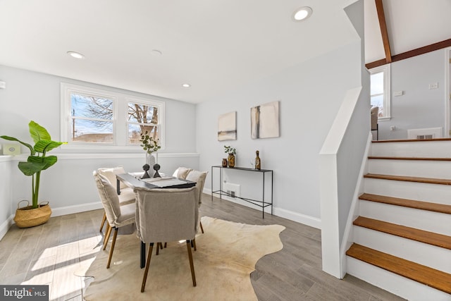 dining room featuring stairs, recessed lighting, baseboards, and light wood-style floors