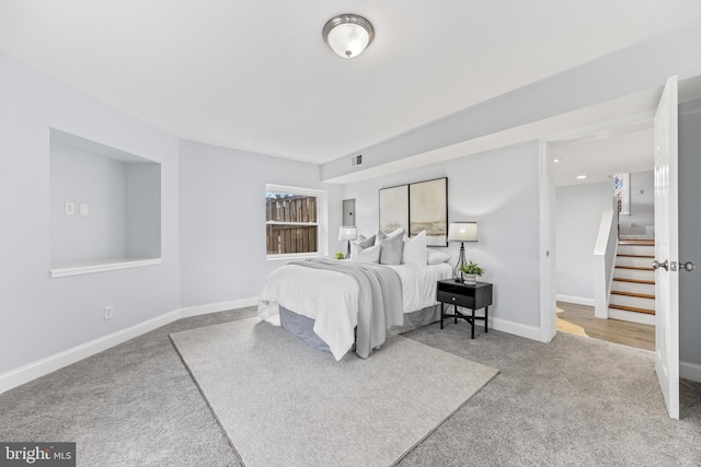 bedroom with carpet flooring, visible vents, and baseboards