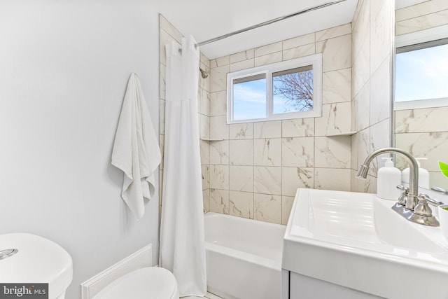 bathroom with a sink, toilet, and shower / tub combo with curtain