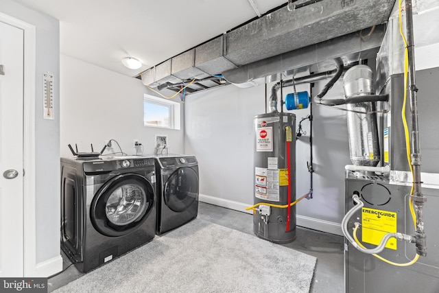 washroom with laundry area, baseboards, independent washer and dryer, heating unit, and water heater