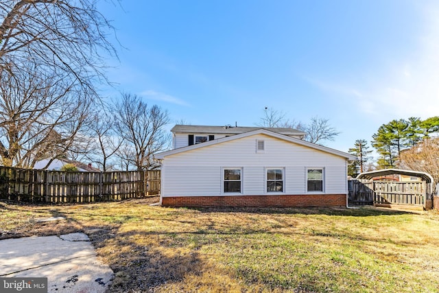 view of side of property featuring a yard, fence, and a carport