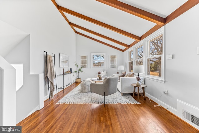 living area featuring visible vents, wood finished floors, high vaulted ceiling, beamed ceiling, and baseboards