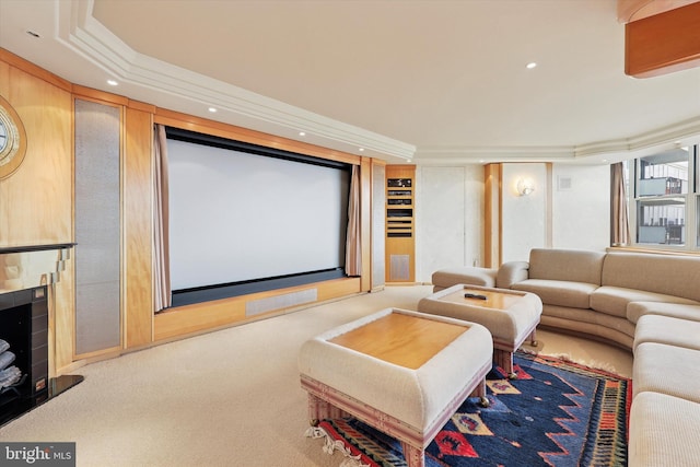 carpeted home theater featuring recessed lighting, a fireplace, and crown molding