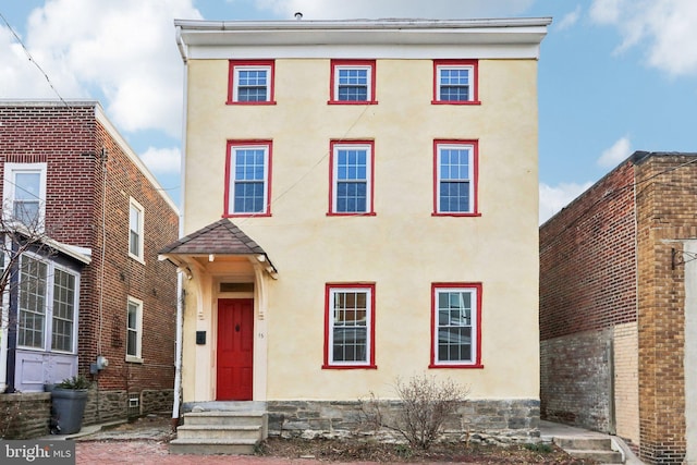 view of front of property featuring entry steps and stucco siding