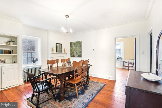 dining space with radiator, light wood-style floors, and a wealth of natural light