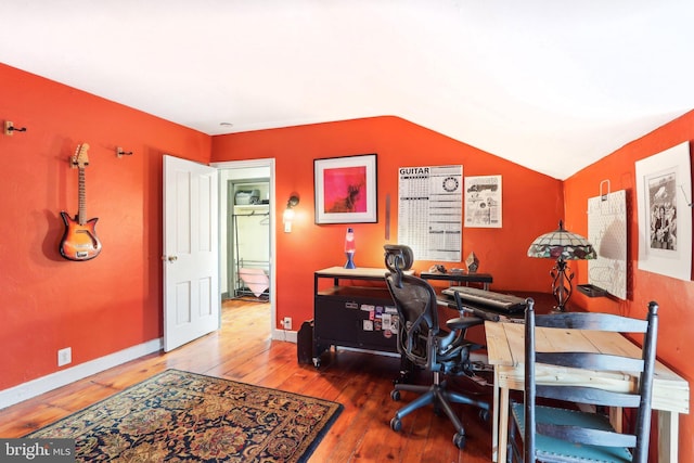 office featuring hardwood / wood-style flooring, baseboards, and vaulted ceiling