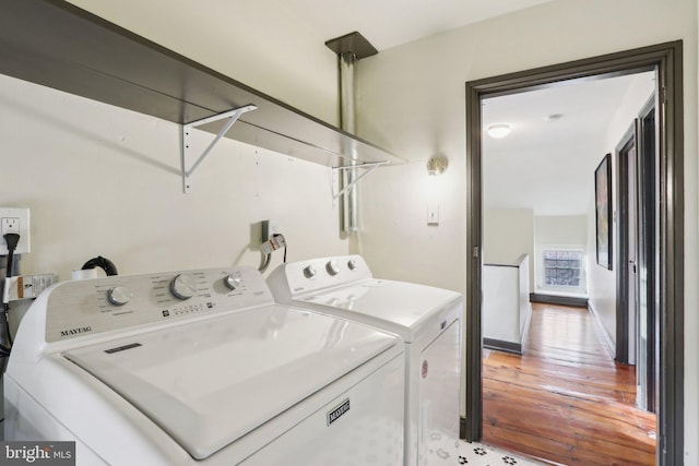 washroom with laundry area, independent washer and dryer, and wood finished floors