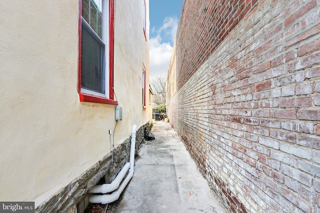 view of side of property featuring brick siding