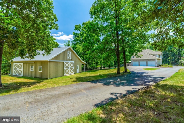 view of side of property with fence and a lawn