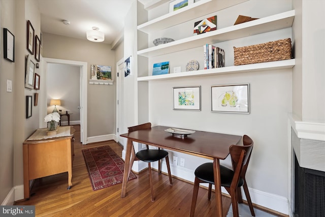 home office with wood finished floors and baseboards