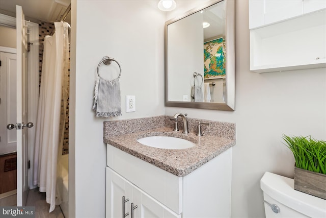 full bath featuring toilet, shower / bathtub combination with curtain, and vanity