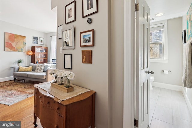 hallway featuring baseboards