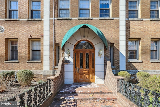 property entrance with brick siding