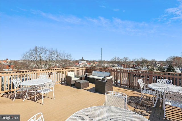 wooden terrace featuring outdoor dining area and an outdoor living space