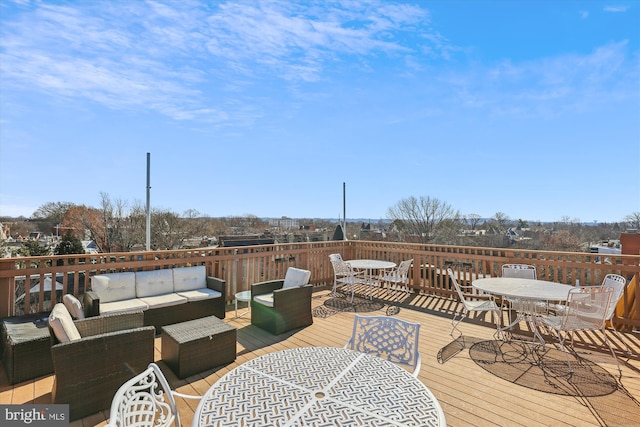 wooden deck with outdoor dining space and outdoor lounge area