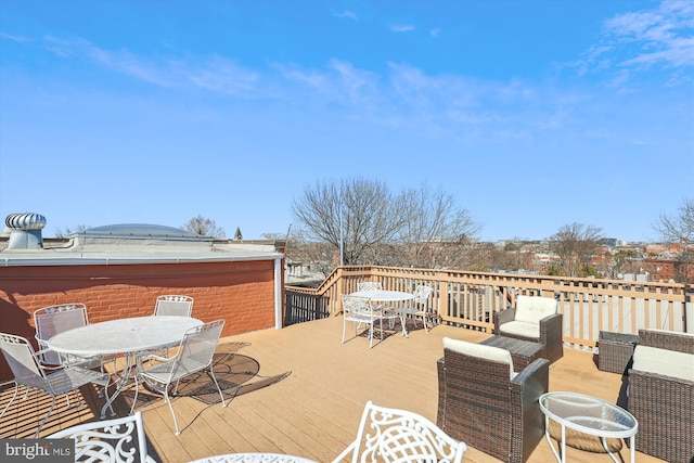 wooden deck featuring outdoor dining area