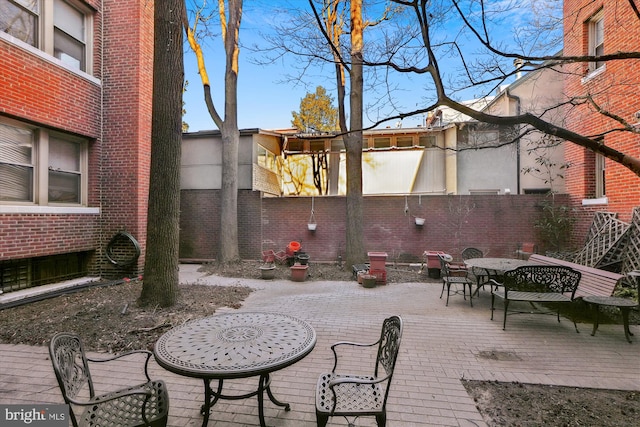 view of patio / terrace with outdoor dining space and fence