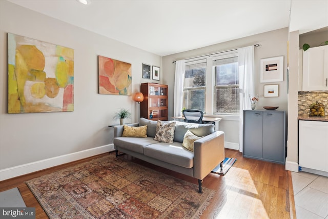 sitting room featuring baseboards and wood finished floors