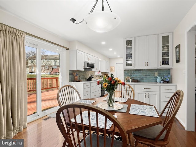 dining room featuring light wood finished floors, visible vents, and recessed lighting