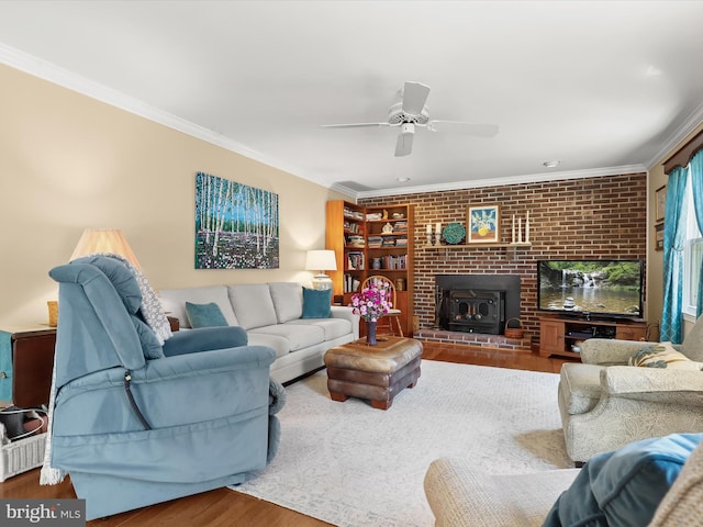 living area featuring wood finished floors, ceiling fan, and ornamental molding