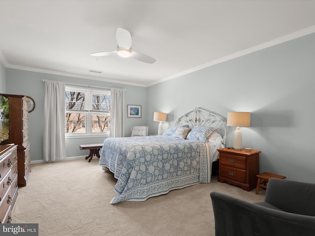 carpeted bedroom featuring baseboards, a ceiling fan, visible vents, and crown molding