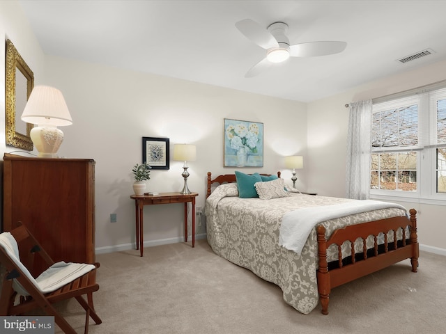 bedroom featuring baseboards, a ceiling fan, visible vents, and carpet flooring