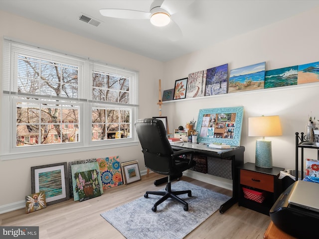 office featuring wood finished floors, visible vents, baseboards, and ceiling fan