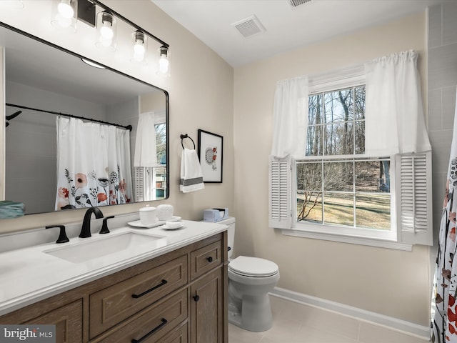 bathroom with tile patterned floors, toilet, baseboards, visible vents, and vanity