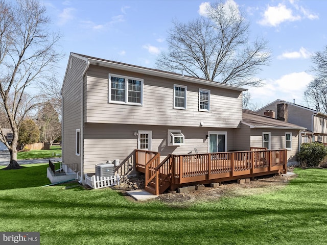 back of property with a lawn, a wooden deck, and central AC unit