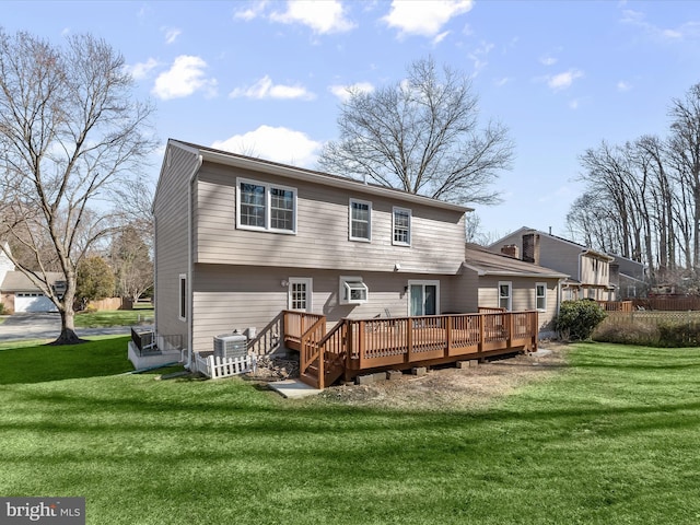 back of house featuring a lawn, central AC unit, and a deck