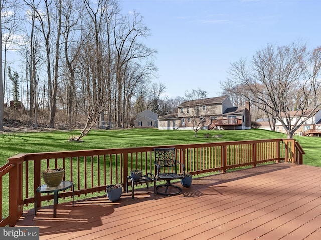 deck with a residential view and a lawn