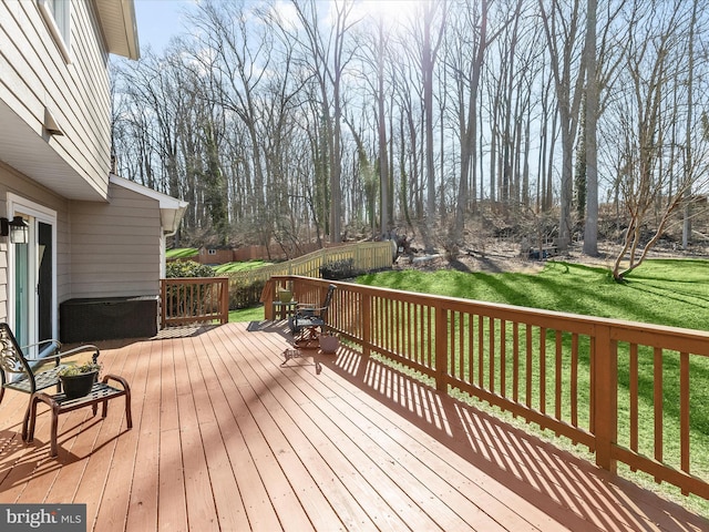 wooden deck featuring a lawn