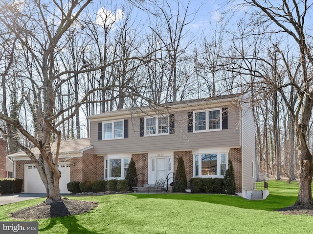 view of front of property featuring concrete driveway, a front lawn, brick siding, and a garage