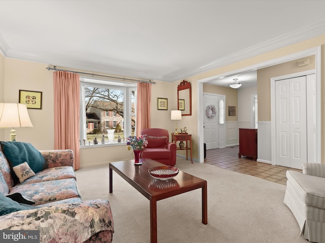 living area featuring carpet floors, ornamental molding, and tile patterned floors