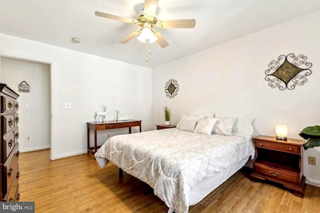 bedroom featuring ceiling fan, wood finished floors, and baseboards