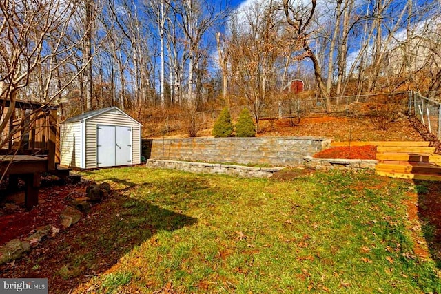 view of yard featuring a shed, a fenced backyard, and an outdoor structure