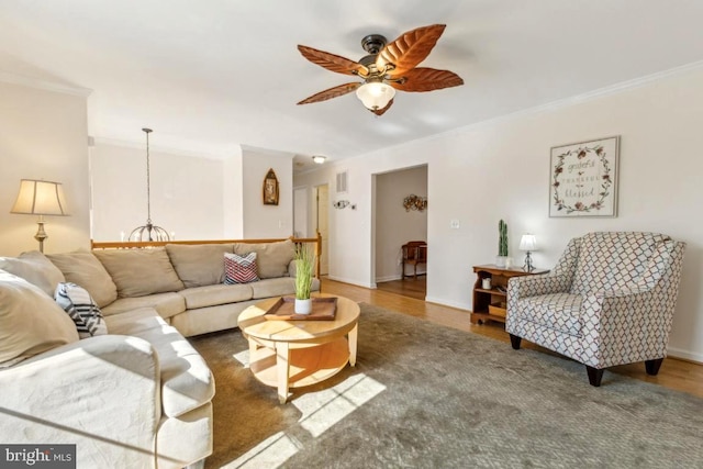 living room with baseboards, dark wood-type flooring, a ceiling fan, and crown molding